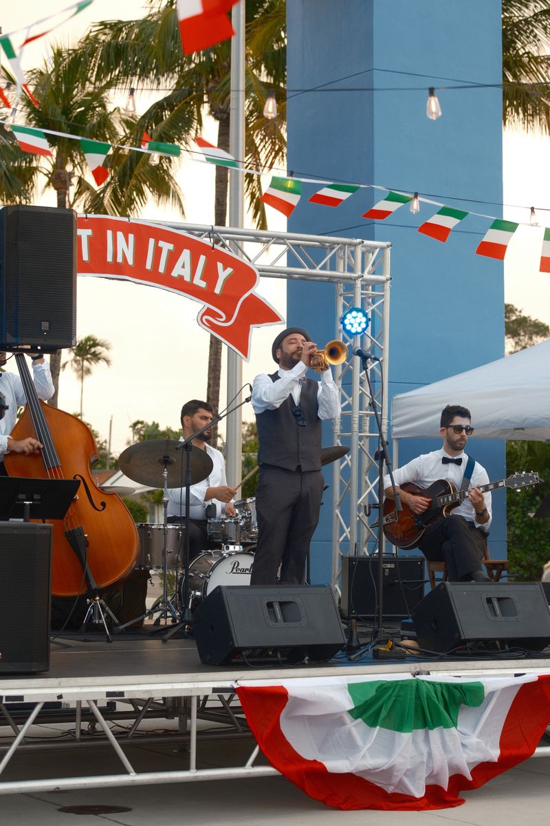 Musicians on stage with Italian flag bunting